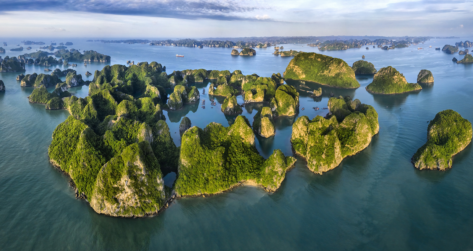 Aerial view Vung Vieng floating fishing village and rock island, aerial view of islands in water Halong Bay Vietnam Asia